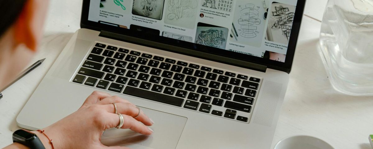Creative work session featuring a woman using a tablet and laptop for design projects.